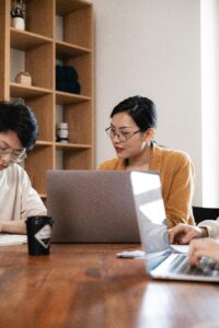 Man and Woman Working Using Laptop